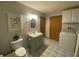 Bathroom with blue vanity and herringbone tiled floors at 71 W County Road 500 S, Clayton, IN 46118