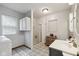 Bright bathroom featuring shower, vanity, and herringbone pattern tile flooring at 71 W County Road 500 S, Clayton, IN 46118