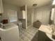 Bright bathroom featuring a modern vanity, spacious shower, and convenient laundry area at 71 W County Road 500 S, Clayton, IN 46118