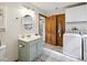 Bathroom featuring vanity, toilet, laundry, and eye-catching herringbone pattern flooring at 71 W County Road 500 S, Clayton, IN 46118