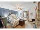 Bright bedroom featuring a ceiling fan, blue accent wall and a trunk at the foot of the bed at 71 W County Road 500 S, Clayton, IN 46118