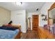 Bedroom featuring hardwood floors, a telescope, and a wall mirror at 71 W County Road 500 S, Clayton, IN 46118