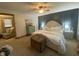 Well-lit bedroom features a bed with wood accents, a green dresser and large windows at 71 W County Road 500 S, Clayton, IN 46118
