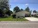 Inviting home with a well-kept lawn and a cozy covered porch with chairs at 71 W County Road 500 S, Clayton, IN 46118