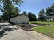 Three-car garage with well-maintained landscaping and garden, enhancing the property's curb appeal at 71 W County Road 500 S, Clayton, IN 46118
