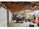 Spacious garage interior with motorcycles and workbench offering ample storage and project space at 71 W County Road 500 S, Clayton, IN 46118