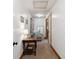 Hallway with carpet flooring, neutral walls, decorative table, and doorways leading to other rooms at 71 W County Road 500 S, Clayton, IN 46118