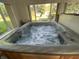 Close-up of a hot tub filled with bubbling water, set within a bright and airy room at 71 W County Road 500 S, Clayton, IN 46118
