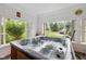 Indoor hot tub room with large windows overlooking the surrounding greenery at 71 W County Road 500 S, Clayton, IN 46118