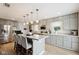 Spacious kitchen featuring stainless appliances, gray cabinets, pendant lighting, and a large island with barstool seating at 71 W County Road 500 S, Clayton, IN 46118