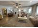 Open living room featuring hardwood floors, a ceiling fan, comfortable seating, and seamless flow to the kitchen at 71 W County Road 500 S, Clayton, IN 46118