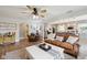 Bright living room with hardwood floors, a large window, and an open layout flowing into the kitchen at 71 W County Road 500 S, Clayton, IN 46118