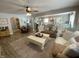 Cozy living room featuring a ceiling fan, neutral rug, and comfortable furniture, ideal for relaxation and entertainment at 71 W County Road 500 S, Clayton, IN 46118