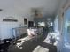 Sun-drenched sun room with dining table, dresser, exercise equipment, and bright windows showcasing the outdoor view at 71 W County Road 500 S, Clayton, IN 46118