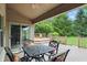 Relaxing back deck with a seating area and lush green landscape view at 7329 Pymbroke Dr, Fishers, IN 46038