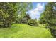 Expansive backyard with lush green lawn, mature trees, and well-maintained landscaping at 7329 Pymbroke Dr, Fishers, IN 46038