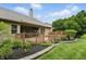 Inviting backyard with a wooden deck, lush landscaping, and a cozy outdoor seating area at 7329 Pymbroke Dr, Fishers, IN 46038