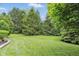 Expansive backyard featuring lush greenery, mature trees, and a well-manicured lawn at 7329 Pymbroke Dr, Fishers, IN 46038