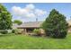 Well-manicured backyard featuring a wooden deck, landscaped garden beds, and a lush green lawn at 7329 Pymbroke Dr, Fishers, IN 46038