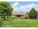 Spacious backyard featuring a well-maintained lawn, a wooden deck, and mature trees at 7329 Pymbroke Dr, Fishers, IN 46038