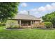 Charming backyard with a wooden deck, a landscaped garden, and a well-maintained lawn at 7329 Pymbroke Dr, Fishers, IN 46038