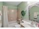 Bathroom with tile shower and tub combo, plus vanity and decorative mirror at 7329 Pymbroke Dr, Fishers, IN 46038