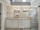 Elegant bathroom showcasing double vanity sinks, framed mirrors, tiled walk-in shower and bench at 7329 Pymbroke Dr, Fishers, IN 46038