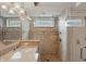 Elegant bathroom showcasing vanity sink with granite counters, framed window and tiled walk-in shower at 7329 Pymbroke Dr, Fishers, IN 46038