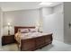 Comfortable bedroom featuring a wooden sleigh bed, matching end tables and an overhead skylight at 7329 Pymbroke Dr, Fishers, IN 46038