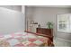 Bedroom features a wooden sleigh bed, dresser with decorative vase and a window with shutters at 7329 Pymbroke Dr, Fishers, IN 46038