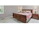 Cozy bedroom displays a wooden sleigh bed, complementing end tables with lamps, and carpet floors at 7329 Pymbroke Dr, Fishers, IN 46038