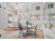 Dining area with a glass table, steps leading to the living area and neutral paint at 7329 Pymbroke Dr, Fishers, IN 46038