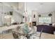Dining area with glass table set, adjacent to the living area and fireplace at 7329 Pymbroke Dr, Fishers, IN 46038