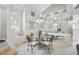 Bright dining room with glass table, cushioned chairs, large mirror and natural light from a window seat at 7329 Pymbroke Dr, Fishers, IN 46038