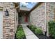 Brick pathway leading to a red front door surrounded by green shrubbery at 7329 Pymbroke Dr, Fishers, IN 46038