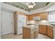 Kitchen with wooden cabinets, granite countertops, tile backsplash, an island, and modern appliances at 7329 Pymbroke Dr, Fishers, IN 46038