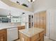 Bright kitchen featuring oak cabinetry, granite countertops, white appliances, and an island at 7329 Pymbroke Dr, Fishers, IN 46038