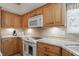 Kitchen with light wood cabinets, granite countertops, tile backsplash, and modern appliances at 7329 Pymbroke Dr, Fishers, IN 46038