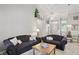 Inviting living room with sofas, bright windows, open to a dining area, offering a cohesive living space at 7329 Pymbroke Dr, Fishers, IN 46038
