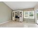 Living room with tile floors, built-in shelving, and a sliding glass door to the outdoor space at 7329 Pymbroke Dr, Fishers, IN 46038