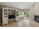Living room with built-in shelving, a fireplace, and sliding glass doors to a deck with outdoor seating at 7329 Pymbroke Dr, Fishers, IN 46038