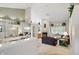 Open-concept living room with vaulted ceilings, fireplace, and large windows with seat at 7329 Pymbroke Dr, Fishers, IN 46038