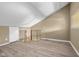 A finished attic with light wood floors and a door to the right at 740 Carya Sq, Columbus, IN 47201