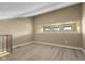 Bright attic room with light wood floors, recessed window and metal railings at 740 Carya Sq, Columbus, IN 47201