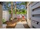Cozy backyard setting with two red chairs, a small table, mature trees, and a privacy fence at 740 Carya Sq, Columbus, IN 47201