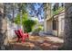 Charming backyard featuring comfortable seating, lush greenery, mature trees and privacy fence at 740 Carya Sq, Columbus, IN 47201