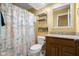 Bright bathroom features a white vanity, tile flooring, and nautical themed shower curtain at 740 Carya Sq, Columbus, IN 47201