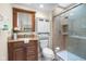 Bathroom with granite vanity, matching medicine cabinet and tiled shower with glass door at 740 Carya Sq, Columbus, IN 47201