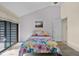 Vaulted bedroom features a colorful floral bedspread and a sliding door at 740 Carya Sq, Columbus, IN 47201