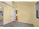 Neutral bedroom featuring laminate flooring, many windows, and closet view to bathroom at 740 Carya Sq, Columbus, IN 47201